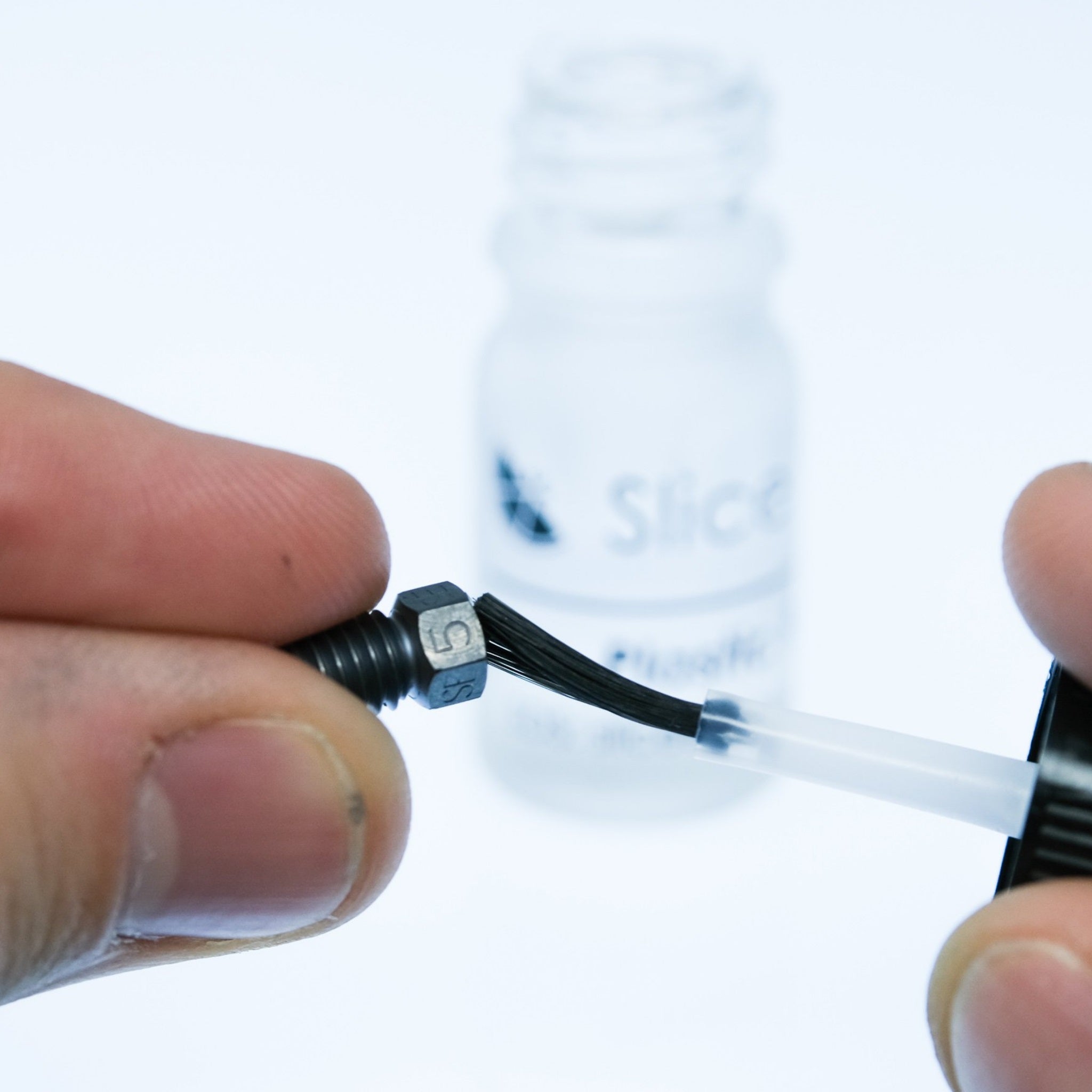 Applying plastic repellent paint to a nozzle